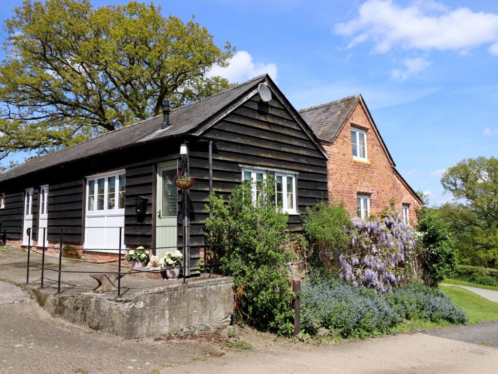 a black and white house with a brick at Upper Pandy Farm in Welshpool