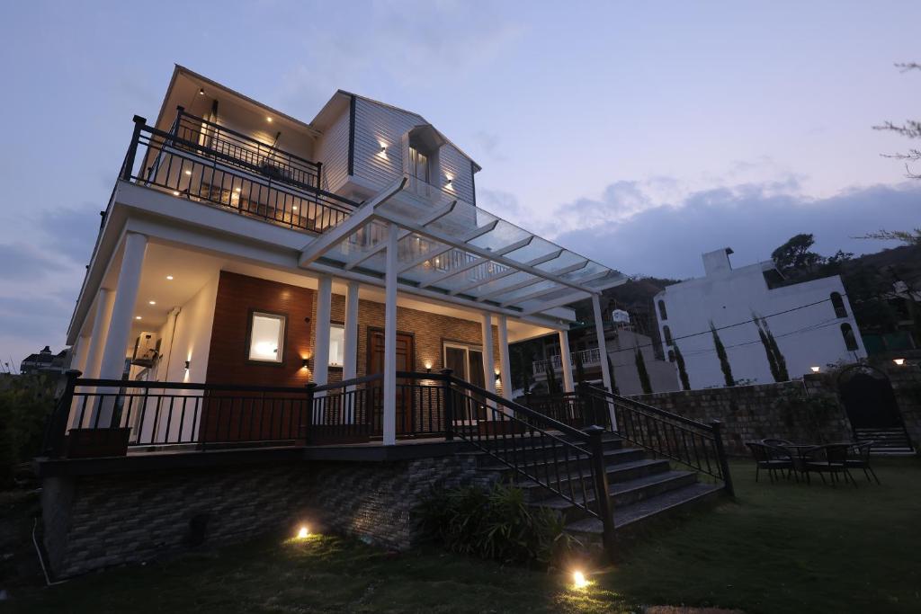 a house with lights on the front of it at Maktain Glance in Dehradun