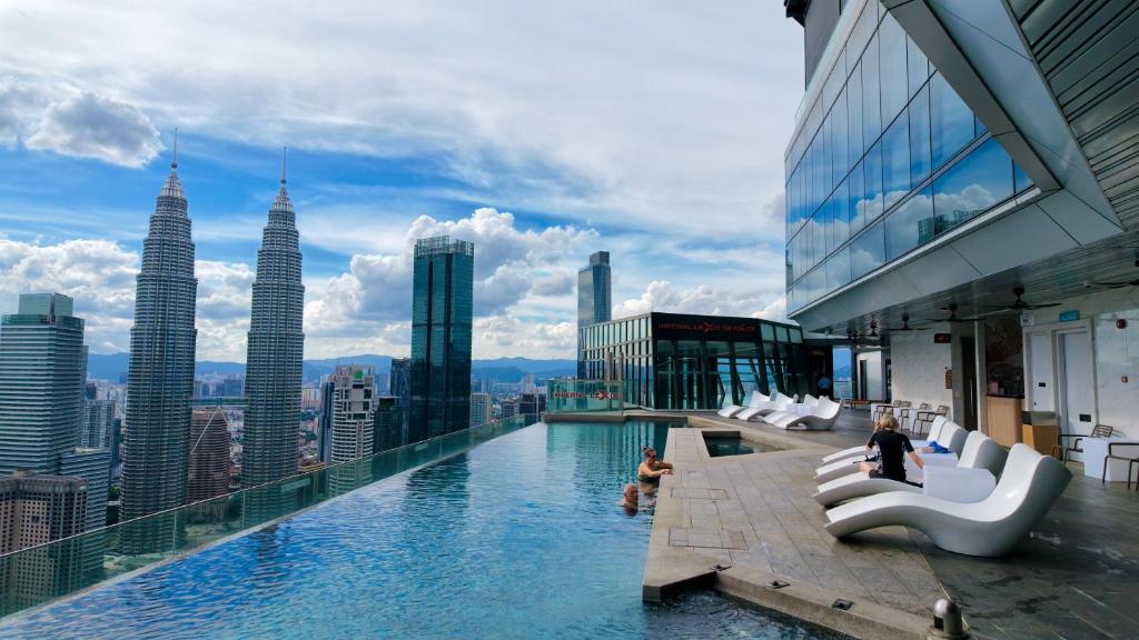 a pool on top of a building with a view of the city at Imperial KLCC Residences in Kuala Lumpur