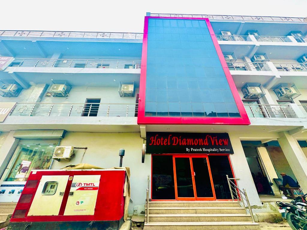 a building with a red door in front of it at Hotel Diamond View in Greater Noida