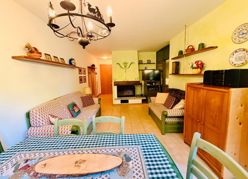 a kitchen and living room with a table and a couch at Dolomites Soundscape - Birds River Snow Ski Bus Bike Hike in Alleghe
