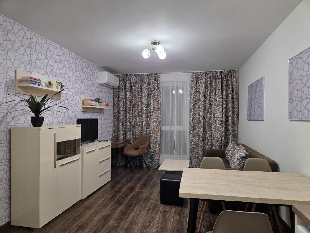 a living room with a kitchen and a dining room at Azaria in Hisarya