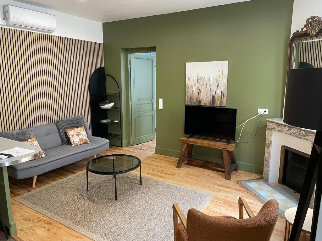 a living room with a couch and a fireplace at Trois Clés Apartment 1 - 1 bed in Eymet