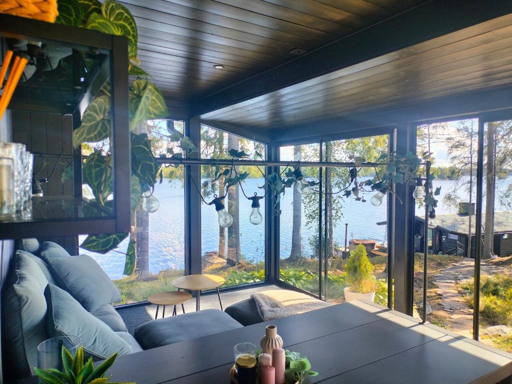 a living room with a couch and a large window at Villa Vaalanto in Pomarkku