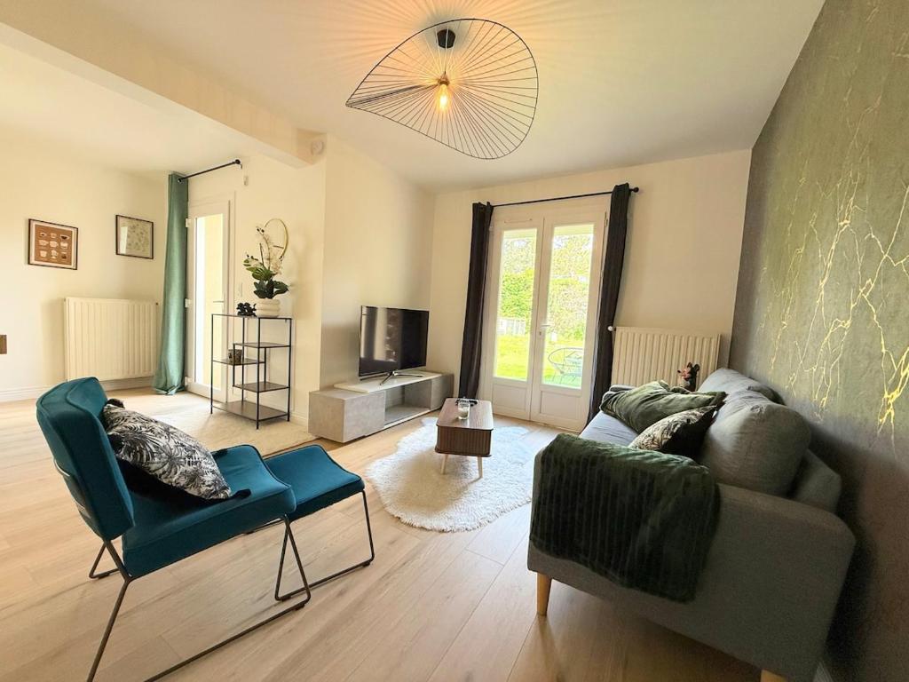 a living room with a couch and chairs and a television at Le Cocon de Vabre, maison calme in Onet le Château