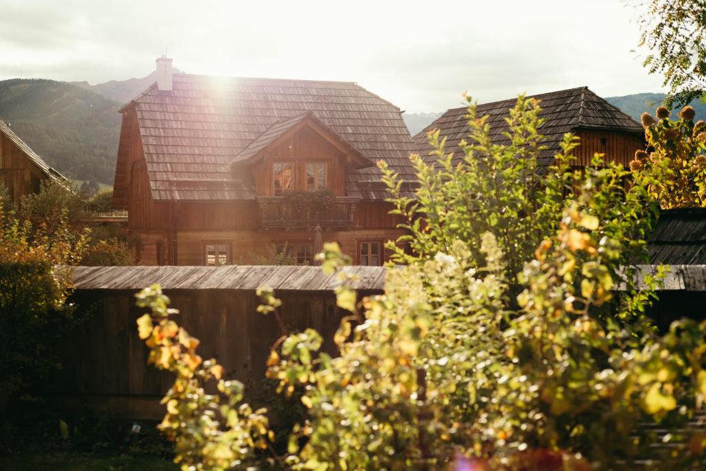 a large wooden house with a roof at st martin chalets in Sankt Michael im Lungau