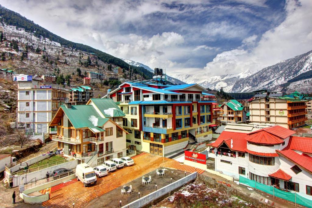 an aerial view of a city with buildings and mountains at The Moniker Resort in Manāli