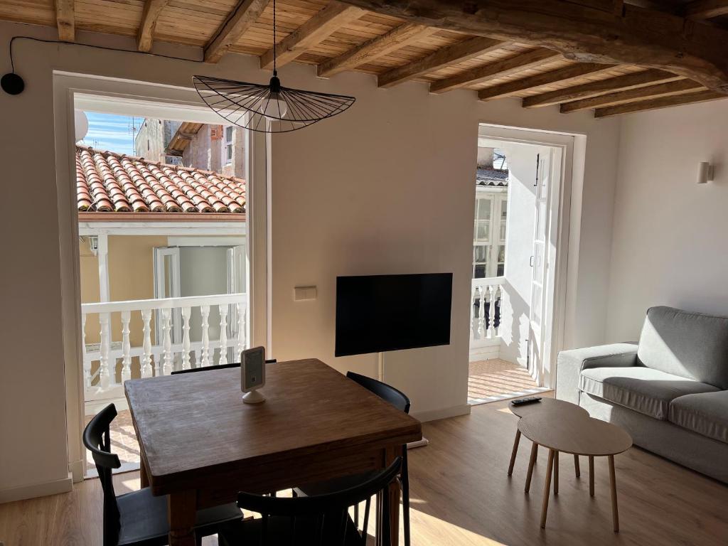 a living room with a table and a couch at Alcacer 4 - 2 in Puentedeume