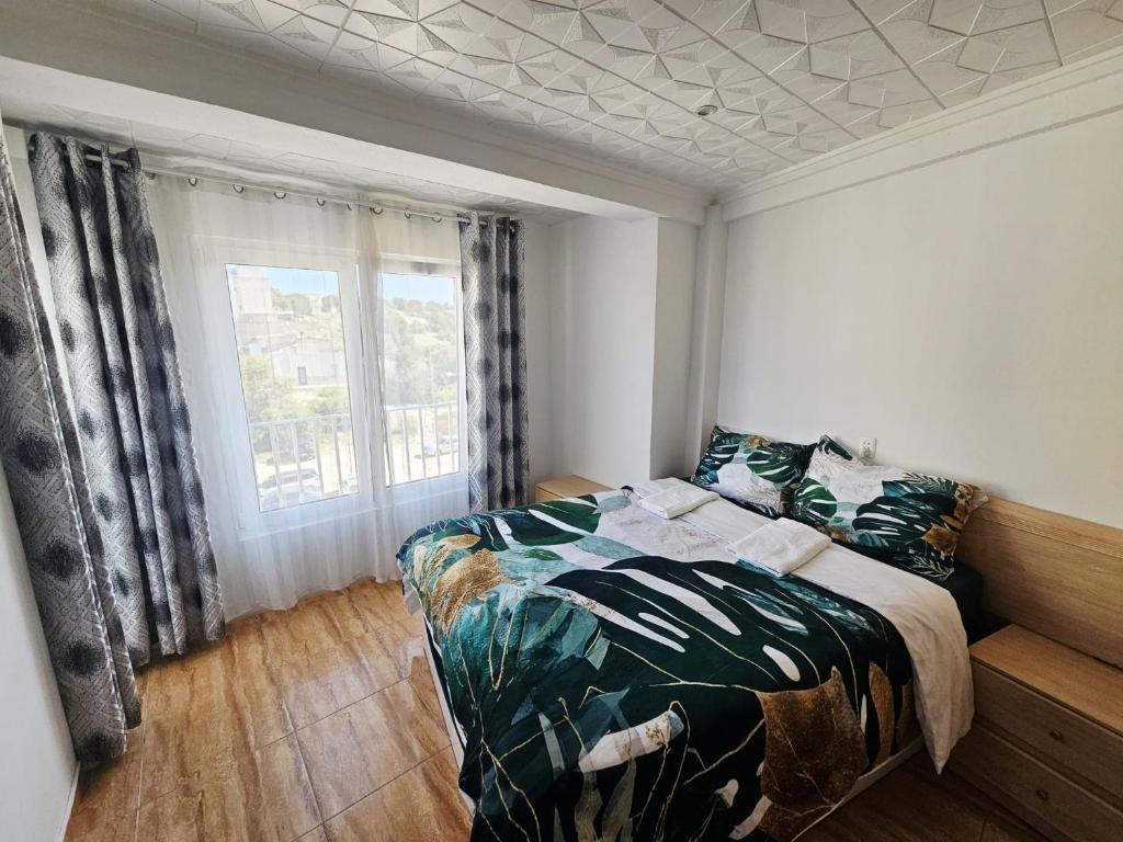 a bedroom with a bed and a window at MarDeSantaPola in Santa Pola