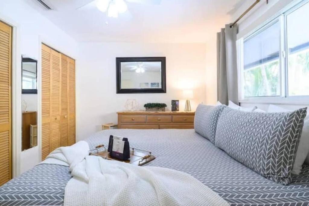 a bedroom with a bed with a phone on it at The peacock villa 1 by Dream Vacation in Fort Lauderdale