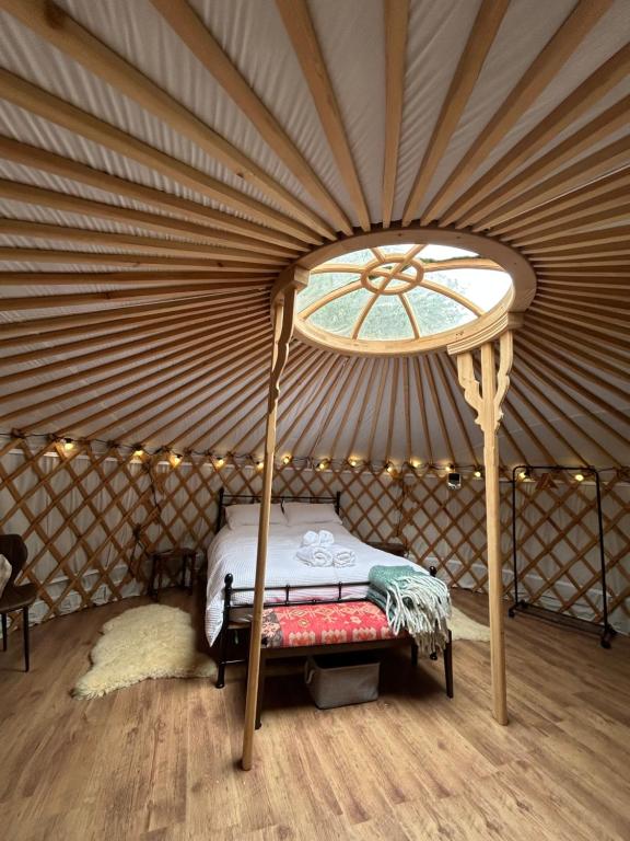 a bedroom with a bed in a yurt at Jimmy's Yurt in Shenley