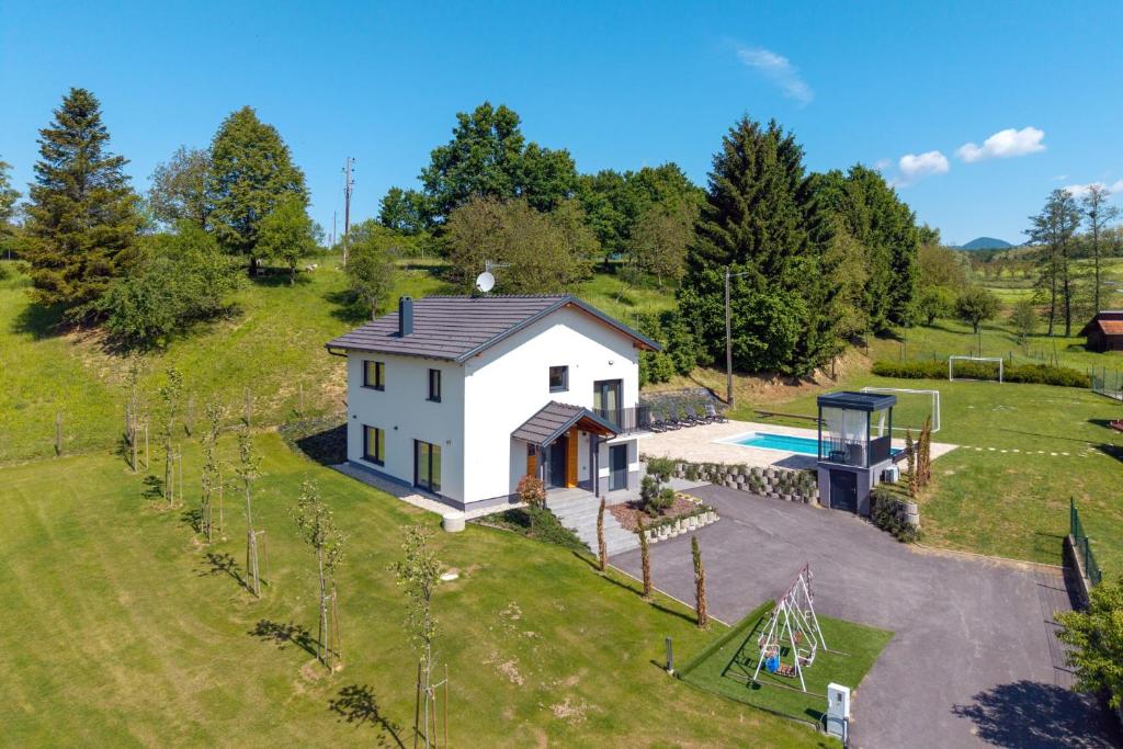 an aerial view of a small white house with a pool at 4 bedroom home Sigma in Zlatar