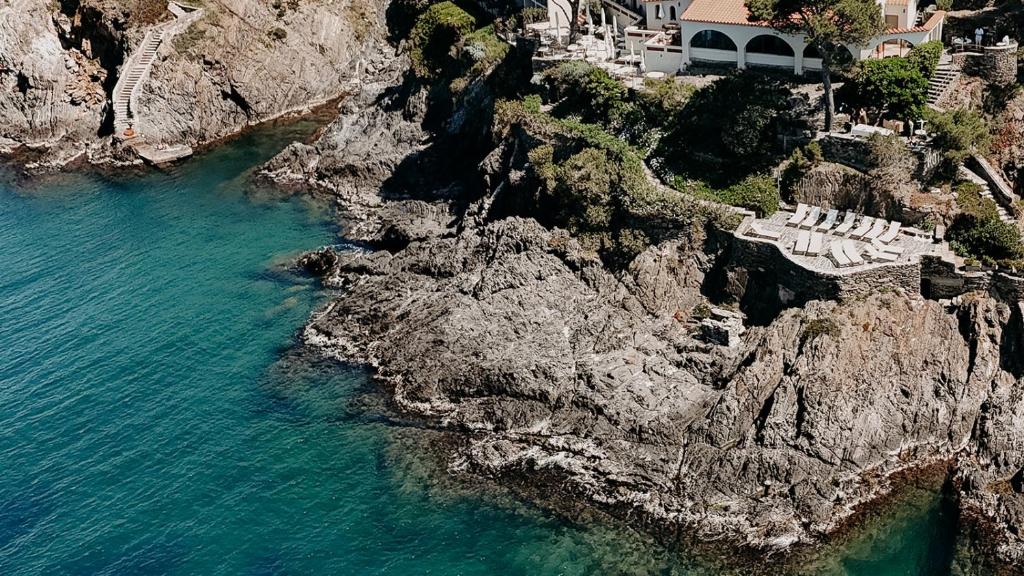 an aerial view of a rocky shore with the ocean at Les Roches Brunes in Collioure