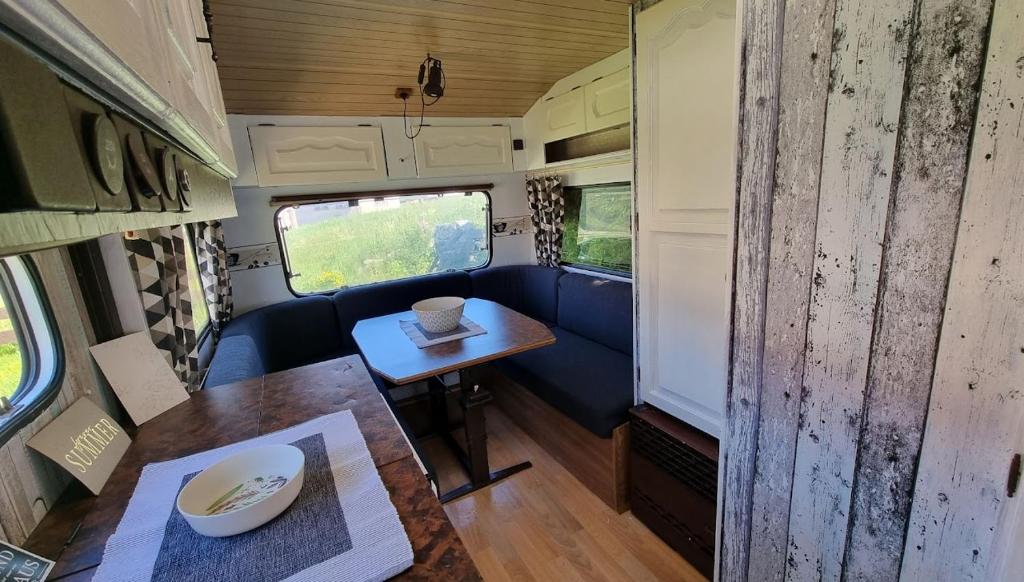 an interior view of an rv with a wooden table at Camping Erzhütte in Rechenberg-Bienenmühle