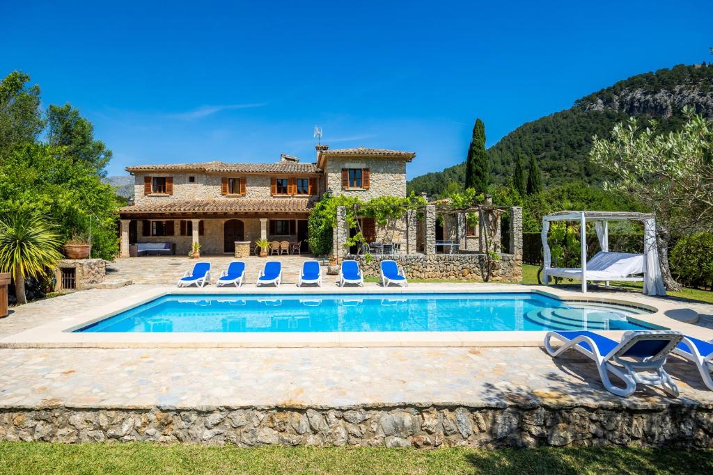a villa with a swimming pool and a house at Villa Cal Apostol in Pollença