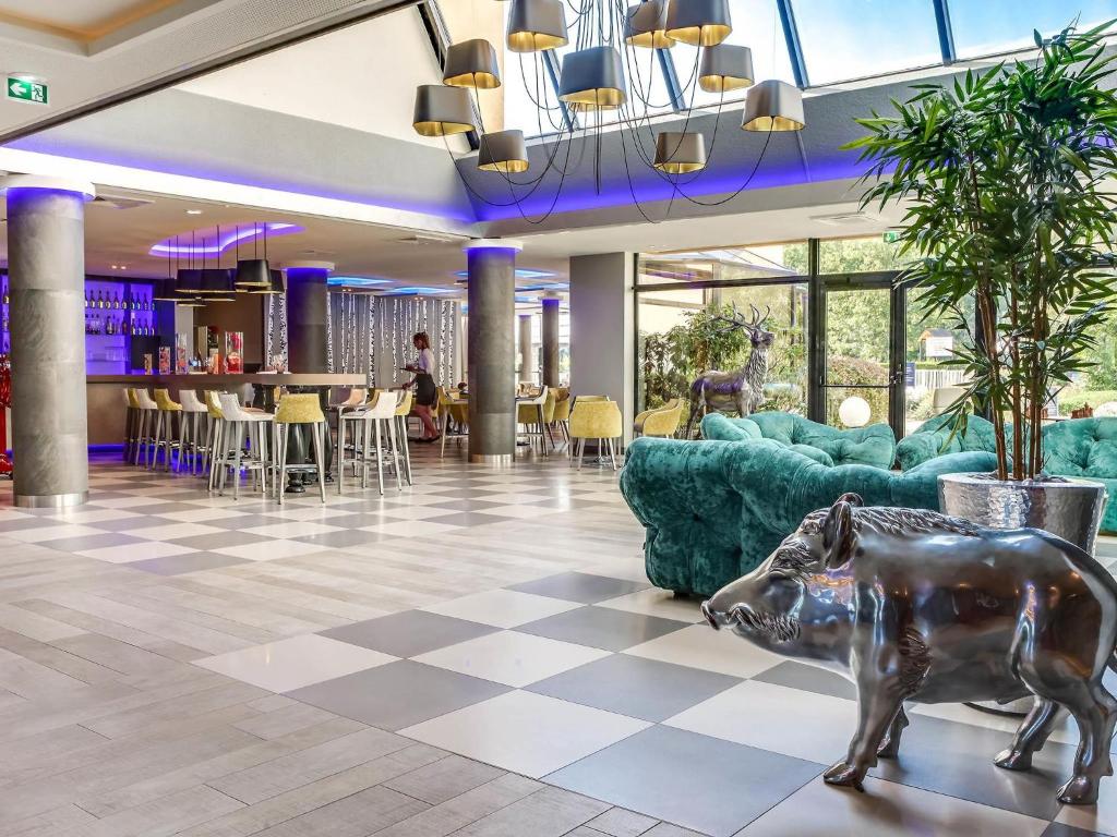 a lobby with a statue of a rhino on the floor at Novotel Orléans Saint Jean de Braye in Saint-Jean-de-Braye