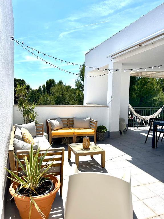 a patio with couches and a table and chairs at Casa Calafat in Calafat