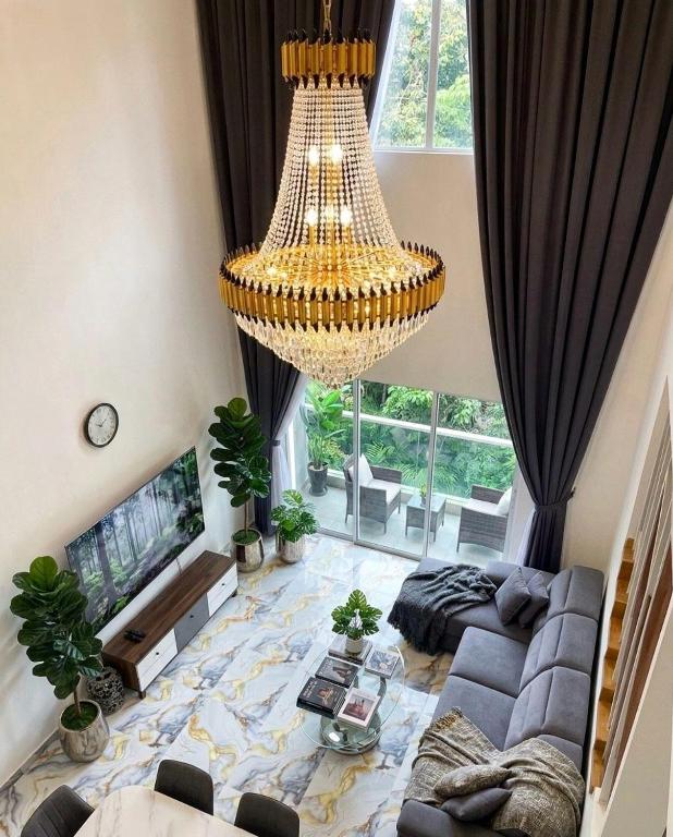 a large living room with a large chandelier at Skyn Heaven Penthouse in Tanah Rata