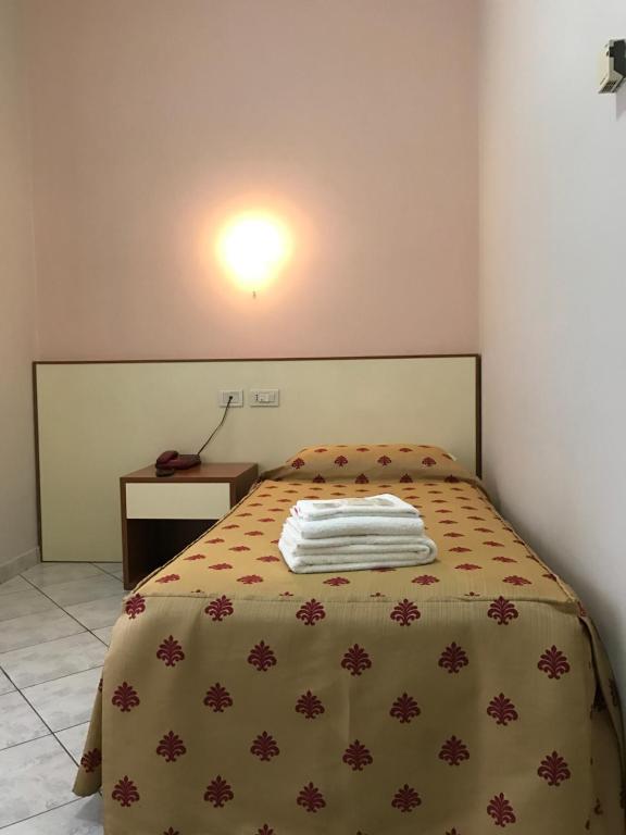 Postel nebo postele na pokoji v ubytování Albergo La Posta Arezzo