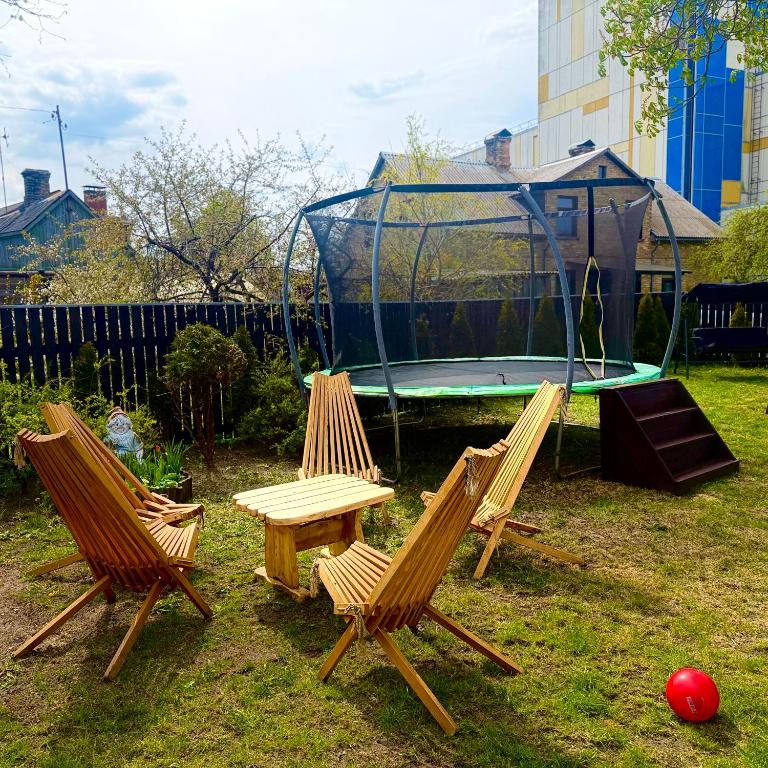 a group of chairs and a table and a playground at Vadim Home 2 in Ventspils