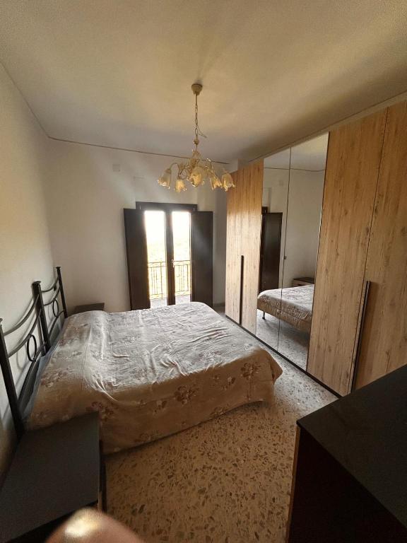 a bedroom with a large bed and a mirror at Dimora Civita in Castelcivita