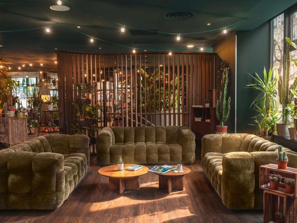 a living room with couches and a table at ibis Paris Bastille Opera in Paris