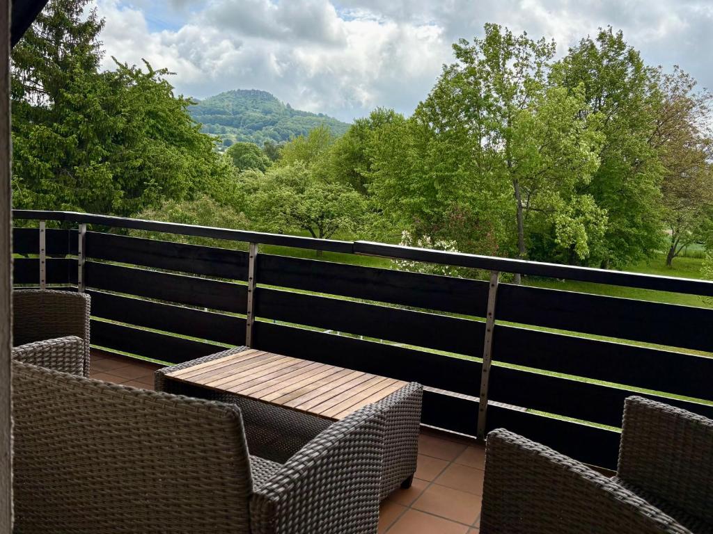 a balcony with chairs and a table with a view at Ferienwohnung Bergblick Bad Staffelstein in Bad Staffelstein
