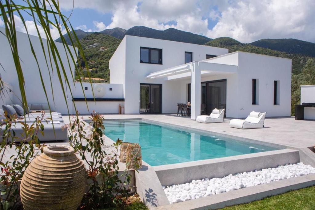 a villa with a swimming pool and a house at Amalfi Twins Villa in Nydri