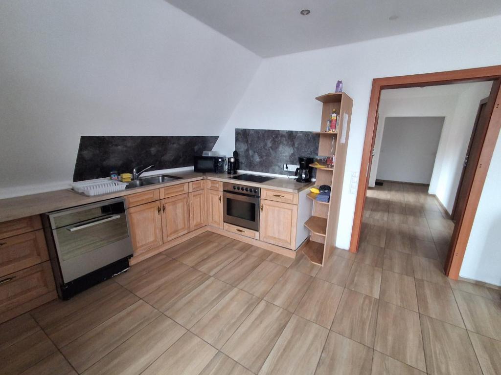 a kitchen with a sink and a stove in it at Monteurzimmer KM in Delbrück
