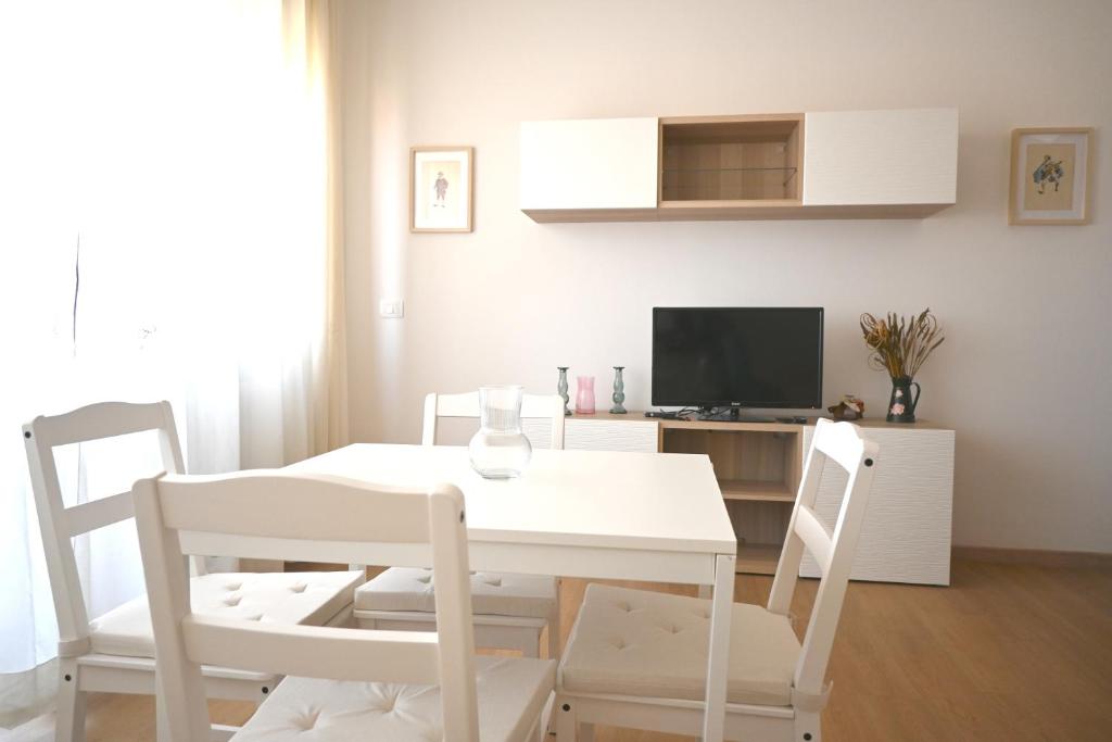 a white dining room with a white table and chairs at SE268 - Marzocca, comodo quadrilocale con garage in Marzocca di Senigallia