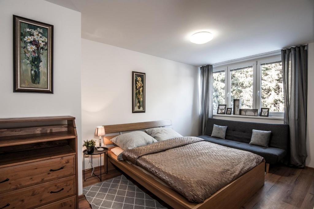A bed or beds in a room at Ski apartmán CHOPOK JASNA
