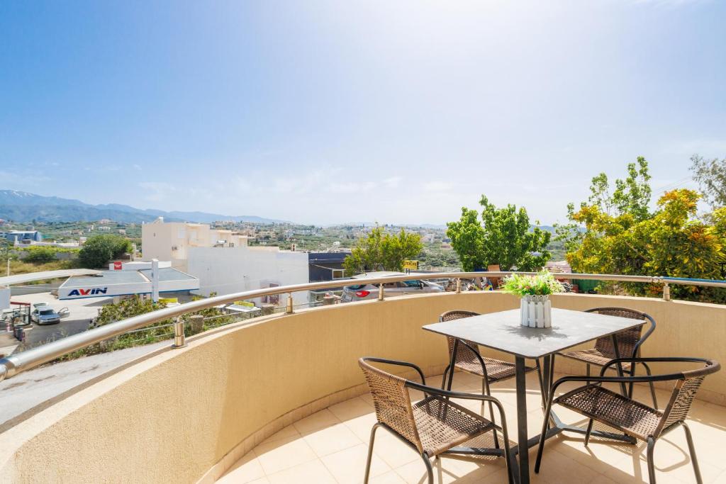 a table and chairs on a balcony with a view at Thalassini in Daratso