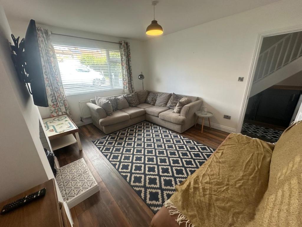 a living room with a couch and a window at The View At Alison Avenue in Bristol