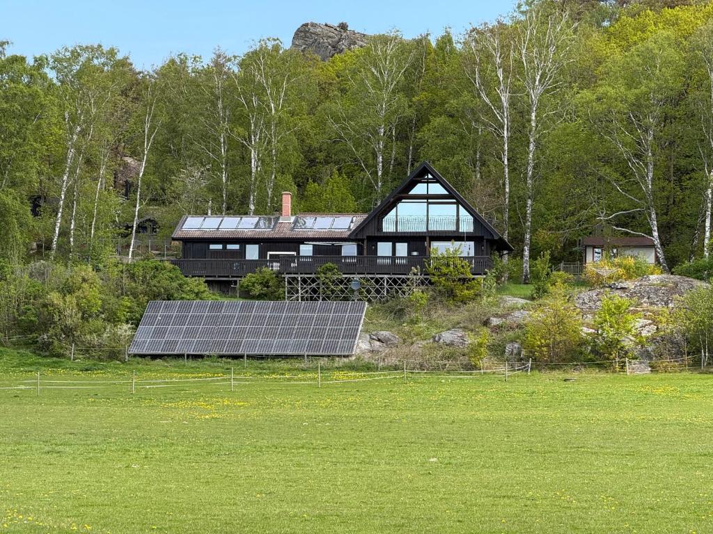 a house with solar panels in front of a field at Rösselviks Gård in Rösselvik