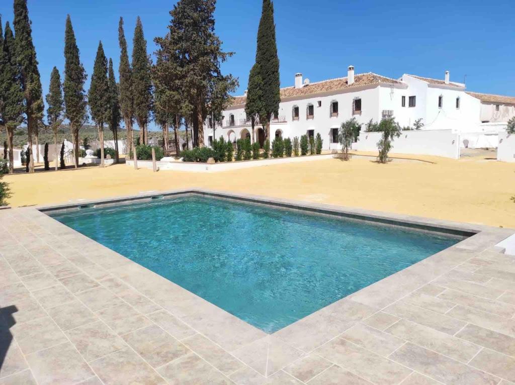 a swimming pool in front of a villa at Cortijo El Solano in Antequera