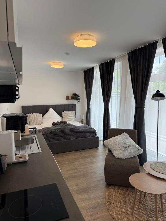 a bedroom with a bed and a living room at Frundsberg-Apartment in Mindelheim