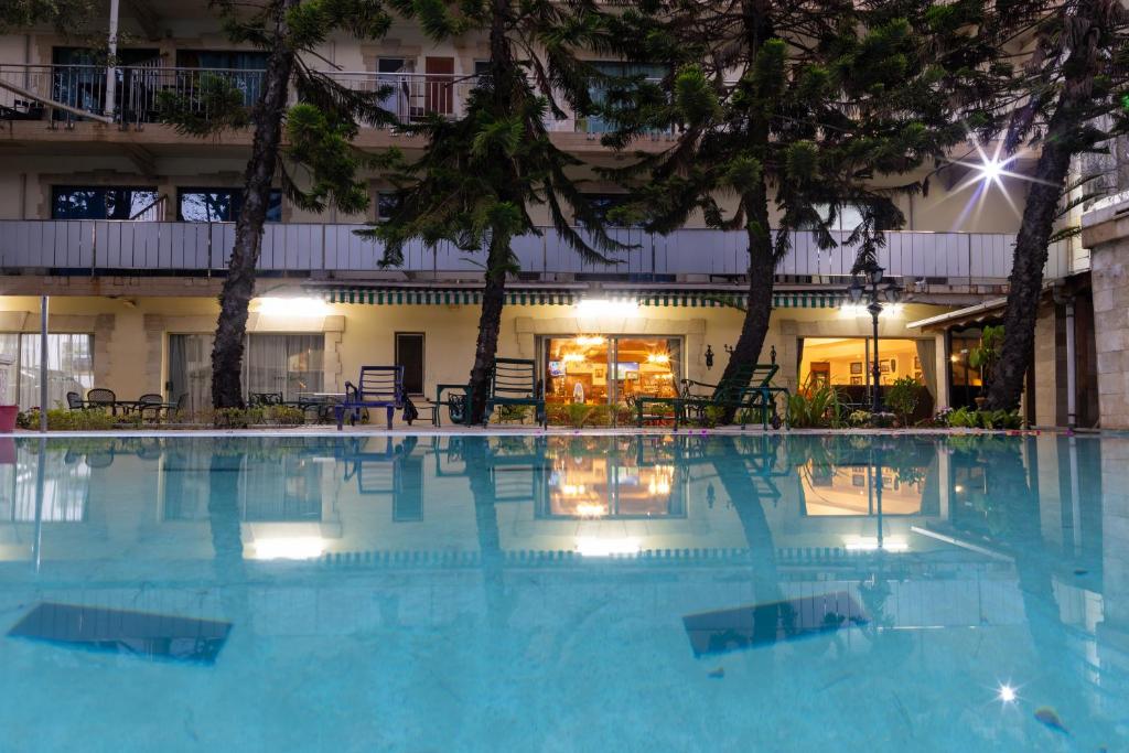 a large swimming pool in front of a building at Sunny Garden in Antananarivo