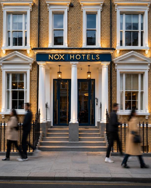 a group of people walking in front of a hotel at NOX Chelsea in London