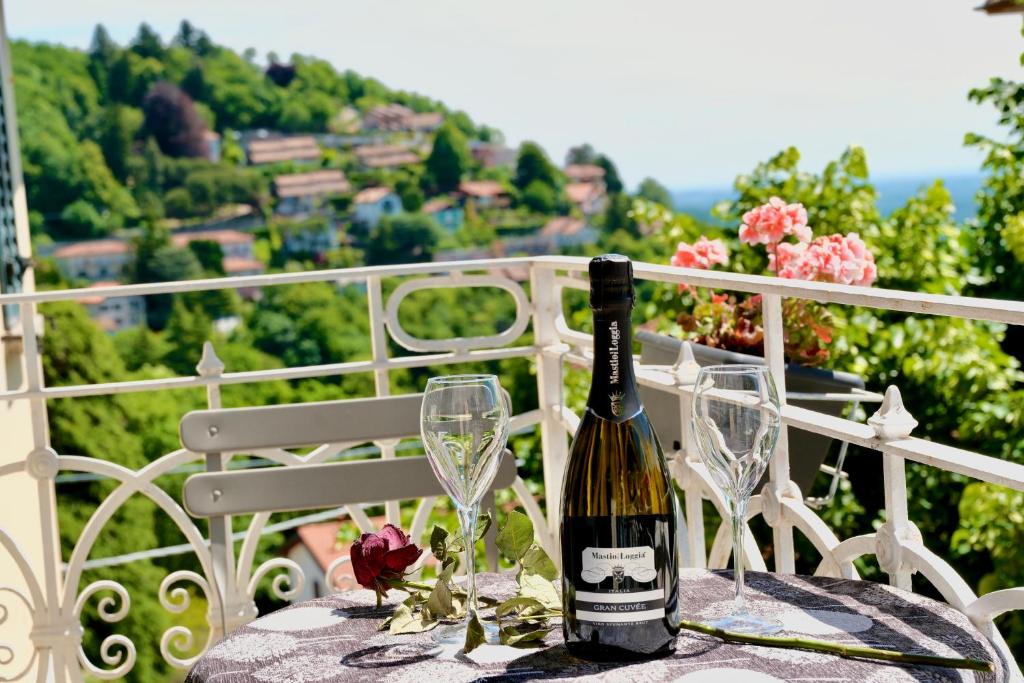 a bottle of wine sitting on a table with glasses at Locanda Milano 1873 in Brunate