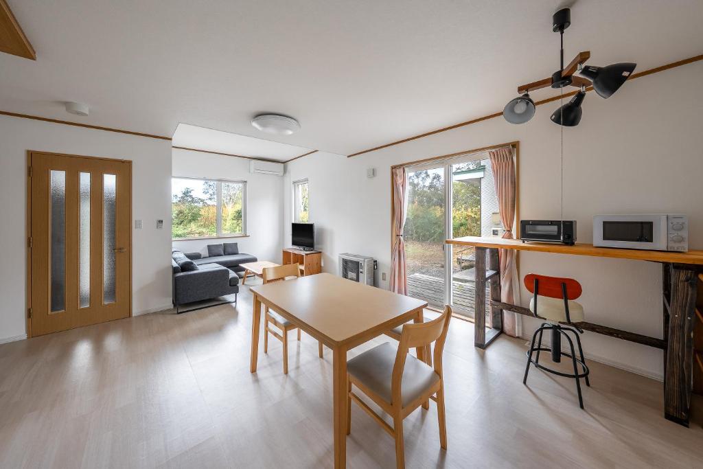 a dining room and living room with a table and chairs at Toya Serenity Stay in Lake Toya