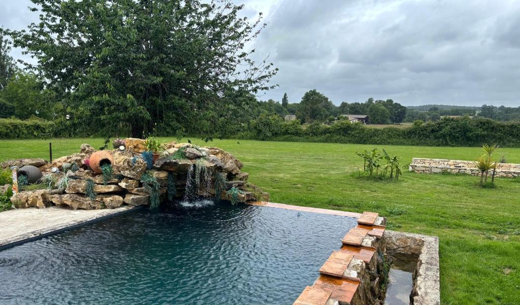 a water fountain in a yard with a field at Villabellevue in Roquebrune