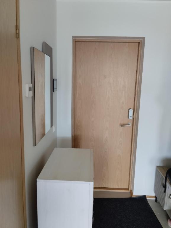 a white refrigerator in a room with a door at Modern Apartment in Tiskre