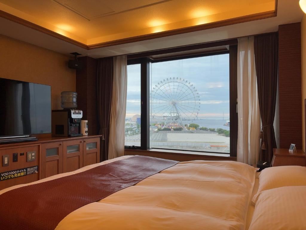 a bedroom with a large window and a large ferris wheel at Hotel Water Gate Nagoya - Love Hotel for couple - in Nagoya