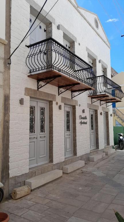 a building with a staircase on the side of it at Charistella Apartment in Symi