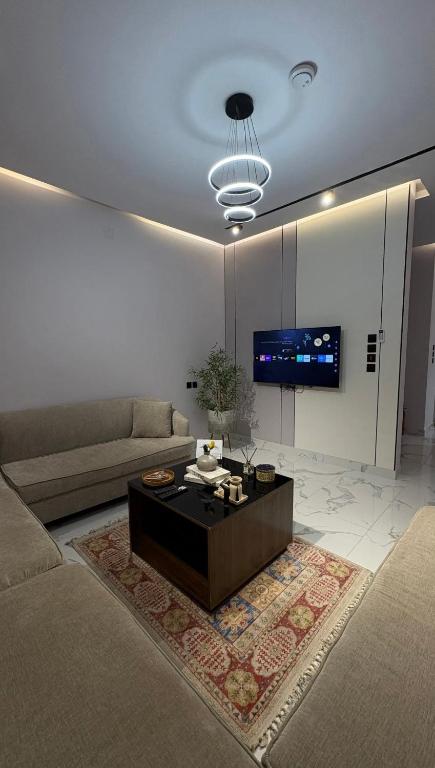 a living room with a couch and a coffee table at شقة فندقية غرفة نوم وصالة in Hail