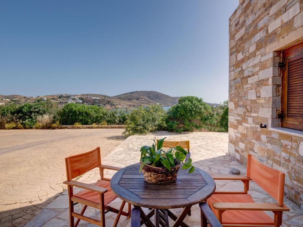 a table with chairs and a plant on a patio at Casa Fabrica in Ano Syros