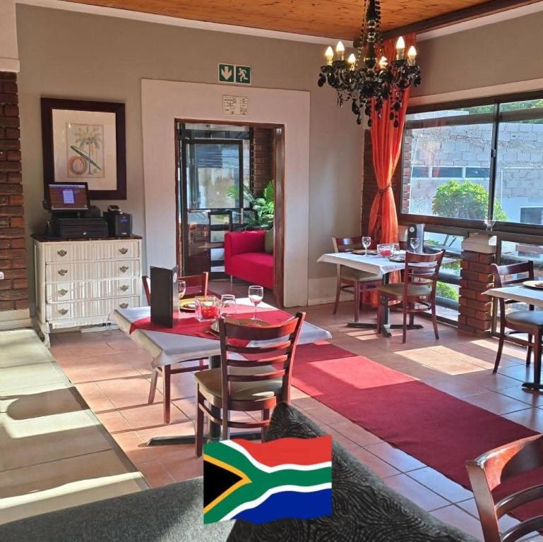 a dining room with a table and some chairs at B Cubed Lodge in Port Shepstone