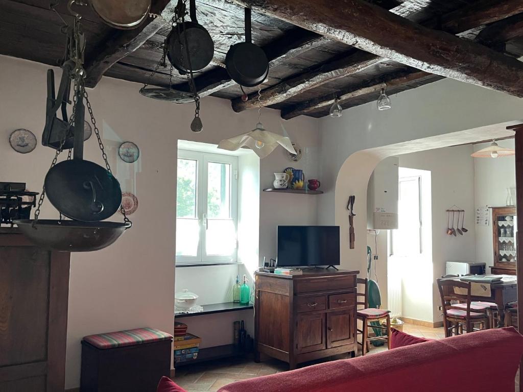 a living room with pots and pans hanging from the ceiling at Casa nel borgo - A Rigadèa in Groppo