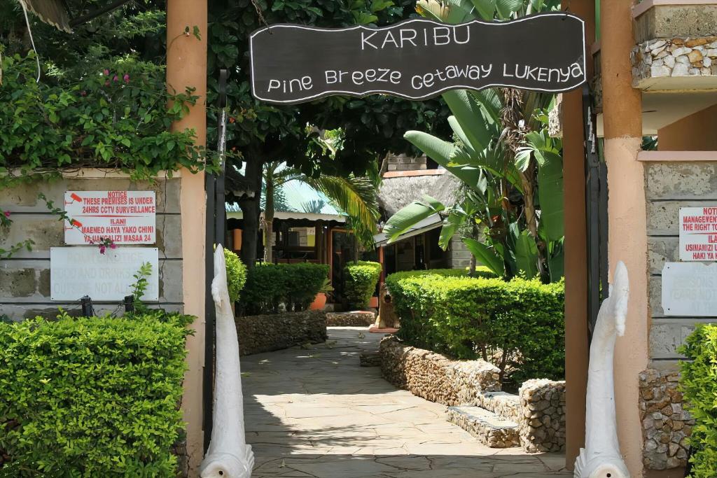a walkway in a building with a sign on it at Pine Breeze Getaway Lukenya in Athi River