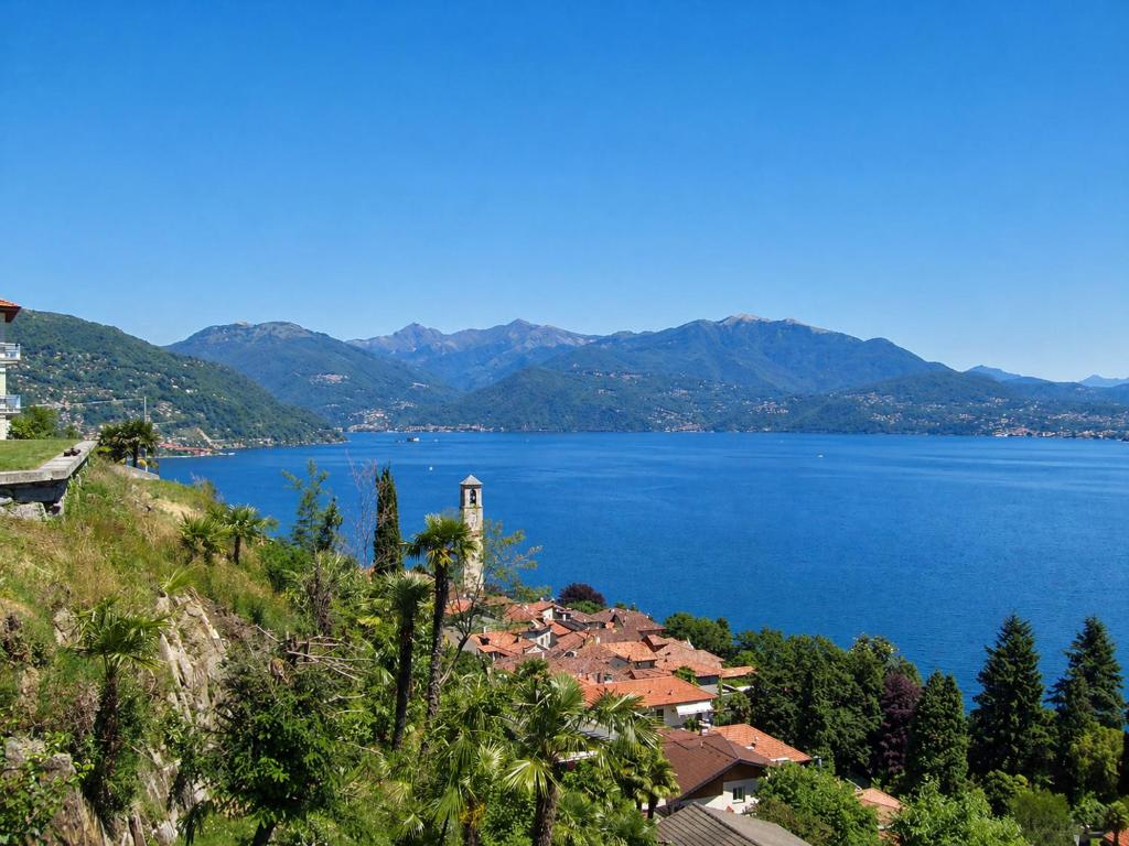 a large body of water with a town on a hill at Casa Coccinella in Oggebbio